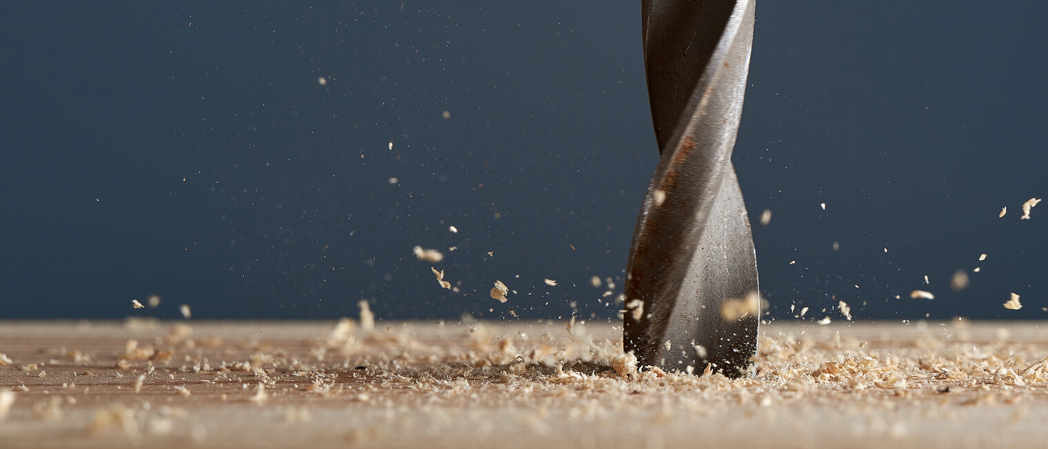 Horizontal shot of drill drills the Board and the sawdust flies. Foreground and background in blur. Schlagwort(e): woodwork, timber, workshop, metal, industry, hole, hardware, handyman, equipment, construct, build, drilling, work, carpenter, drill, instrument, carpentry, improvement, sawdust, wood, construction, macro, bit, tool, home, concept, activity, craft, board, electrical, wooden, fix, industrial, manual, plank, planking, renovation, electric, repair, sharp, spiral, steel, auger, borer, close-up, contractor, copy space, gray, blur, woodwork, timber, workshop, metal, industry, hole, hardware, handyman, equipment, construct, build, drilling, work, carpenter, drill, instrument, carpentry, improvement, sawdust, wood, construction, macro, bit, tool, home, concept, activity, craft, board, electrical, wooden, fix, industrial, manual, plank, planking, renovation, electric, repair, sharp, spiral, steel, auger, borer, close-up, contractor, copy space, gray, blur