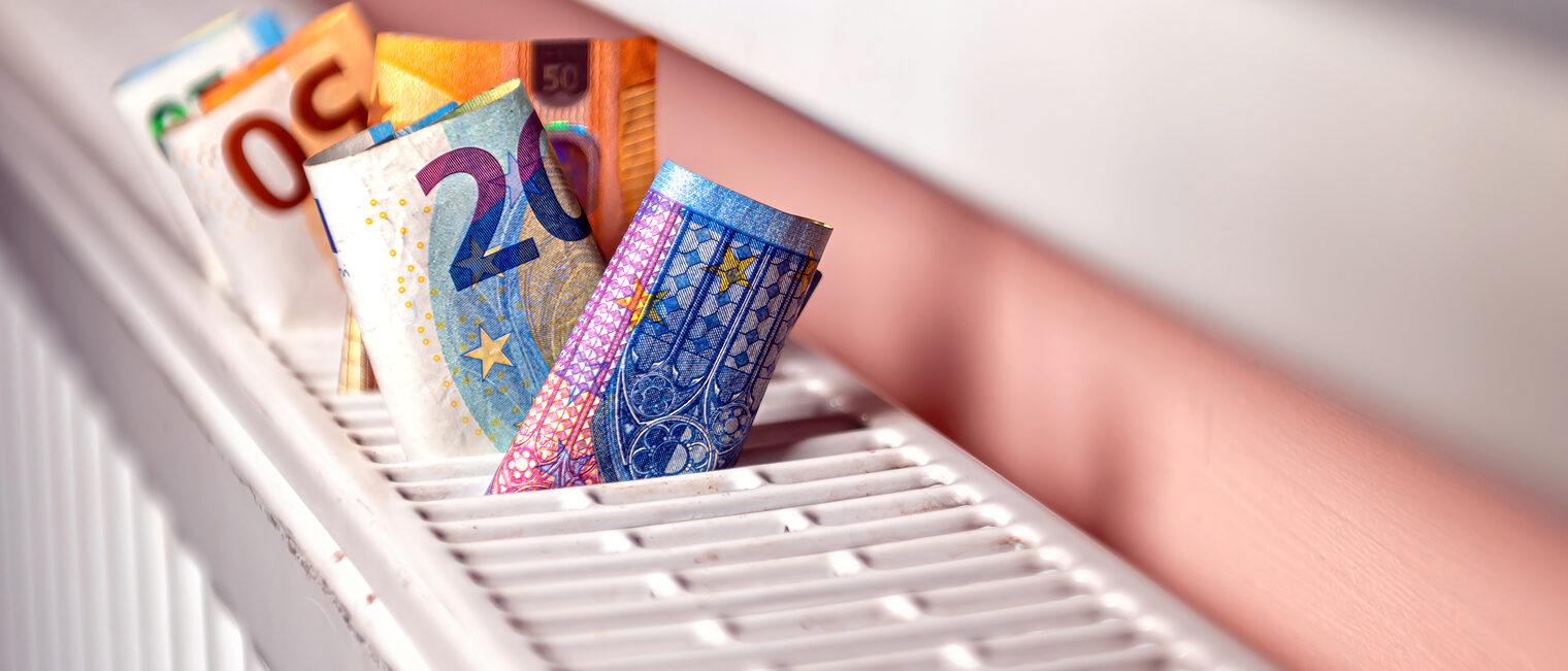 euro banknotes in a central heating radiator, the concept of expensive heating costs, close-up Schlagwort(e): cost, banknote, energy, radiator, euro, money, expensive, heat, temperature, finance, warm, winter, cold, consumption, home, efficiency, save, concept, price, economy, thermostat, cash, symbol, gas, bill, economical, high, heating, reduce, power, heater, house, central, waste, oil, hot, low, adjusting, season, currency, pay, expense, control, building, frost, thermal, warmth, saving, closeup, household