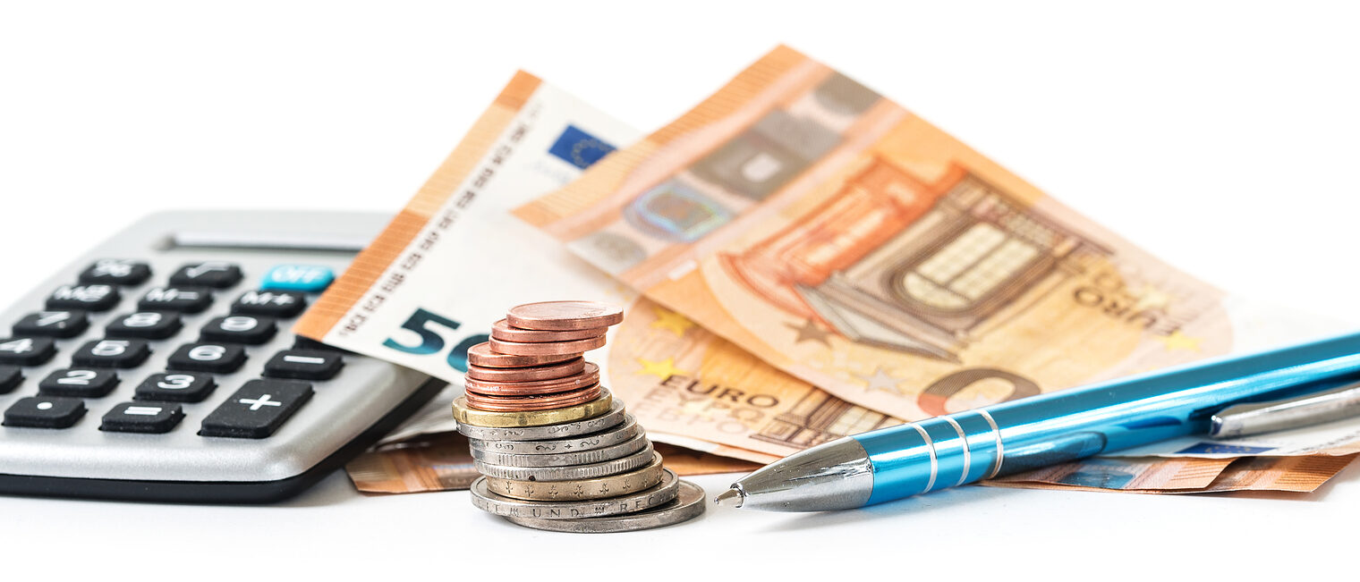 financial planning with coins and euro banknotes, a calculator and a pen isolated on a white background, panoramic banner format, selected focus, narrow depth of field Schlagwort(e): finance, coins, banknotes, euro, calculator, pen, money, banking, household, business, cash, credit, exchange, income, investment, note, pay, rate, loan, save, spend, wealth, accounting, costs, budget, pension, provision, expenses, poverty, social, welfare, tax, isolated, planning, isolated, white, background, panoramic, banner, web page, office, concept, economy